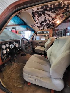 the interior of an old car with leather seats