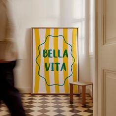 a yellow and white poster sitting on top of a checkered floor next to a chair