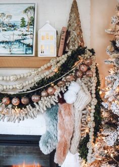 a decorated christmas tree in front of a fireplace