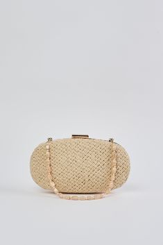 In a Natural tone, this versatile clutch is an ideal summer accessory. With a hard casing featuring a hand woven outer, we adore the detachable beaded shell strap and easy metal snap closure. Crafted to complement our Corsica collection, this charming oval-shaped bag is a must-have clutch of the season. Elegant Clutch As Fashion Accessory For Spring, Elegant Spring Fashion Accessory Clutch, Elegant Beige Clutch For Summer, Chic Summer Clutch For Fashion, Chic Straw Bag With Pearl Handle, Beaded Beige Straw Bag, Chic Beige Woven Clutch, Elegant Woven Clutch For Vacation, Beaded Rectangular Beach Clutch