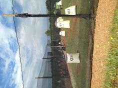 the baseball field is fenced off with plastic bags