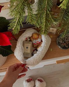 a woman's hand is holding a christmas ornament