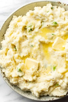 a bowl filled with mashed potatoes topped with butter