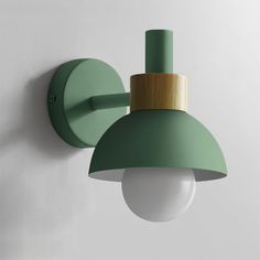 a green wall light mounted on the side of a white wall