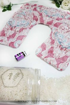 the contents of a toilet seat cover laid out on top of a white table with flowers