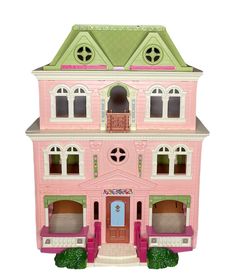 a pink doll house with green roof and two stories on the second story, sitting in front of a white background