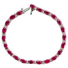 Beautiful Le Vian GIA certified ruby and diamond bracelet. 22 spectacular oval brilliant cut purple/red rubies totaling 11:00cts, spaced with 44 round brilliant cut, near colorless diamonds set in 14k white gold. 7.25 inches in length. Built in box catch and underside safety. GIA certified as natural, with low heat. Because of the exquisite color change in different lighting, the rubies are not easily photographed. We believe the main photograph is the most accurate when the bracelet is viewed in person. 22 oval purple red rubies, MI approx. 11.00cts GIA Certificate # 5222590980 44 round diamonds, H-I SI approx. .44cts 14k white gold Tested: 14k Hallmark: Le Vian 12.5 grams Bracelet : 7.25 Inches Width:4.3mm Thickness/depth:4.5mm Antique Wedding Bands, Diamond Sapphire Engagement Ring, Antique Engagement Rings Vintage, Bracelet Tennis, Gold Link Bracelet, Antique Bracelets, Vintage Sapphire, Diamond Engagement Rings Vintage, Le Vian