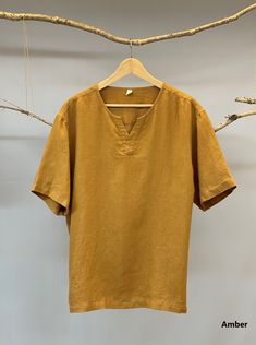 "Nothing beats a simple linen tee in a hot and humid summer. Made from 100% pure linen fabric, this split neck linen tee is soft and very breathable, making you feel relaxed indoor and outdoor. -100% prewashed linen fabric - Short sleeves - Easy to dry - Split collar - Relaxed fit Please provide your shoulder width, chest measurement ( measured around the widest part please) and your height along with your order in the note to seller box. Don't see your size? Please message us for custom made or Medieval Outfit, Teal Burgundy, Simple Linen, Short Sleeve Linen Shirt, Cotton Slip, Linen Tee, Linen Shirt Men, Linen Tshirts, Blazer Set