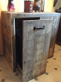 a wooden cabinet sitting on top of a tiled floor