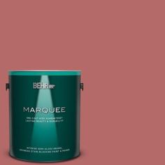 the behr marquee paint is shown in an open, dark green color