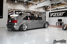 a grey car parked inside of a garage