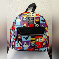 Disney Nightmare Before Christmas Mini Backpack Nwt, Never Worn, Never Used. Perfect For You Walt Disney World Vacation!! This Style Is Not Available At The Parks. Backpack Has Characters In Multi-Colored Panels, Including Jack, Sally, And Oogie. These Designs Are On The Front, Sides, And Bottom Of The Bag. Straps Are Black. Metal Finishing/Zippers Are Silver Tone. Interior Fabric Is Black, Same As The Straps. Pictures Are Of The Actual Bag I Will Send! Bag Is Approximately 10" Tall, 5" Wide At Disney Themed Multicolor Bags For Fan Events, Themed Multicolor Bags For Disney Fan Events, Multicolor Backpack For Disney Fan Events, Disney Style Bags With Zipper For Back To School, Disney Back To School Bags With Zipper Closure, Back To School Disney Bags With Zipper, Multicolor Disney Standard Backpack, Themed Multicolor Standard Backpack, Halloween Standard Backpack With Zipper Closure