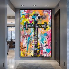 a large colorful painting on the wall in an office hallway with doors open to another room