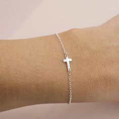 Our mini sideways cross bracelet will become a favorite in your collection and makes a great gift too! A solid .925 sterling silver cross hangs sideways along this bracelet. Chain is .925 sterling silver with a sturdy clasp and is adjustable so you can get the perfect fit. Works great layered with other bracelets or all alone. DETAILS - solid sterling silver - adjustable length - can be worn 6-8 inches long Wear it layered with our other dainty silver bracelets: Box chain bracelet: https://etsy. Everyday Silver Crucifix Jewelry, Silver Crucifix Jewelry For Everyday Wear, Minimalist Hypoallergenic Cross Jewelry, Nickel Free Silver Cross Bracelets, Adjustable Everyday Rosary Bracelet With Cross, Adjustable Everyday Cross Pendant Jewelry, Nickel-free Silver Cross Bracelets, Dainty Adjustable Silver Rosary Bracelet, Dainty Silver Adjustable Rosary Bracelet