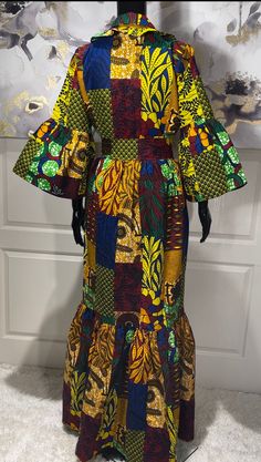 The KEMI African Print Maxi Dress is the perfect dress for any occassion, including holiday parties. A beautiful Ankara patchwork print dress that will make you look stunning. Be ready for all the compliments!  Look Unique. Know You Are Beautiful. Available in sizes S-2XL Yellow, Maroon, Blue, Green, And Black In Color Ankara Patchwork Print  Tiered Dress Ruffled Shirt Colar Ruffled Sleeves  Ruffled Hem Cloth Belt CARE Hand Wash Or Machine Wash On Cool Gentle Cycle. Line Dry, Steam Iron. Fitted Green Maxi Dress For Holiday, Traditional Fitted Midi Dress For Party, Fitted Patchwork Maxi Dress, Fitted Yellow Patchwork Dress, Bohemian Patchwork Party Dresses, Elegant Multicolor Patchwork Midi Dress, Elegant Multicolor Maxi Dress For Festive Occasions, Multicolor Patchwork Dress For Party, Yellow Patchwork Maxi Dress