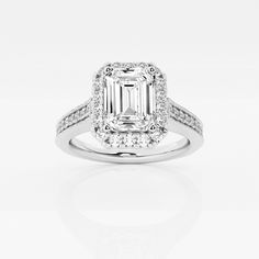 an emerald cut diamond ring with diamonds around it