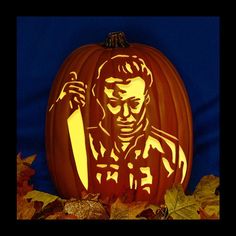 a carved pumpkin with a man holding a knife