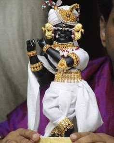 a person holding a small statue in their hands