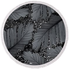 black and white photograph of leaves with glitters on them round beach towel featuring the image of