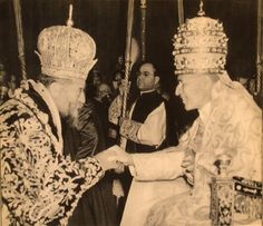 an old photo of two men shaking hands with each other in front of some people