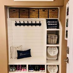 a white shelf filled with baskets and shoes