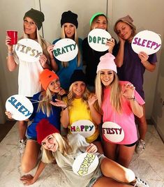 a group of women holding up signs that say happy