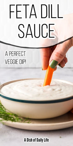 a person dipping a carrot into a bowl with the words feta dill sauce