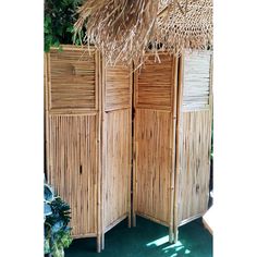 an outdoor room divider made out of bamboo