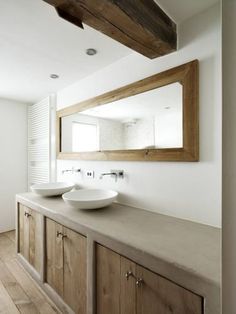 a bathroom with two sinks and a large mirror