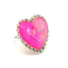 Details: Features a gradient resin heart with silver glitter embedded (*note that every heart is slightly different since colors were hand poured per each heart) Heart is surrounded by sparkly iridescent crystal rhinestones Handmade Silver plated ring band Measurements: Heart is a little over 1" in size Adjustable band to fit most adult ring sizes *Only a few left! See 2nd photo to see the remaining hearts that your item will be made from. Matching necklace and earrings available: just search for "trinket" *Hand Made to order* Please expect a 2 week delay from order placement to shipment. Every order includes free gift packaging! Have questions? Click on the message bubble at the bottom right of your screen to instant chat with me! Pretty Engagement Rings, Candy Jewelry, Iridescent Crystal, House Gifts, Ring Pendant Necklace, Tea Collection, Plated Ring, Ring Sizes, Matching Necklaces