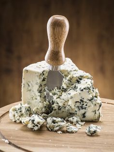 a block of blue cheese with spinach on top