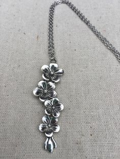 This is so unique and pretty!  Elongated flower pendant necklace.  It has incredible detail and design.  The perfect necklace for any botanical lover.  It would make a very lovely gift.The pendant is made from allergy free plated silver and measures 2 1/4” long by 1/2” wide.  It hangs from a simple 18” stainless steel necklace chain with a lobster clasp.  I have matching earrings in my shop, if you would like the whole set.  Here is the link............ https://etsy.me/2RL7mtu Thanks for stoppin Metal Flower Charm Necklaces, Delicate Silver Flower Charm Necklace, Metal Flower Necklace For Gift, Silver Delicate Flower Charm Necklace, Metal Jewelry With Flower Charm And Pendant, Silver Flower-shaped Necklace With Adjustable Chain, Silver Flower Necklace With Adjustable Chain, Adjustable Flower Necklace Nickel Free, Silver Flower Pendant Necklace With Adjustable Chain