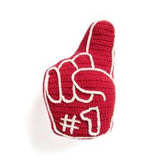 a crocheted red and white hand with the number 11 on it's thumb