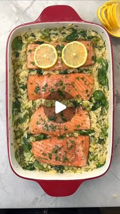 salmon and rice with lemons in a red dish