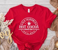 "Old Fashioned Hot Cocoa Served Daily Open All Winter Shirt, Christmas Hot Cocoa Shirt, Funny Christmas Shirt, Christmas Gift,Christmas Shirt WELCOME TO \"GoldenShirtDesign\" ! High quality and super soft, comfortable shirt. Made with top of the line vinyl and pressed with a professional grade heat press. All our simple color ones like White, Black, and Red are 100% Cotton. All our Heathered Colors are cotton/polyester blend and they are super comfy soft! SIZING AND COLORS Make sure you check ou Hot Cocoa Shirt, Old Fashioned Hot Cocoa, Christmas Hot Cocoa, Winter Shirts, Funny Christmas Shirts, Simple Colors, Funny Christmas, Christmas Shirt, Hot Cocoa