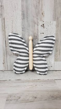 a black and white striped butterfly on a wooden wall