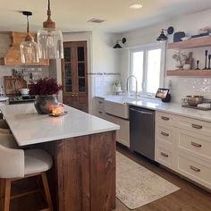 a kitchen with an island, sink and dishwasher