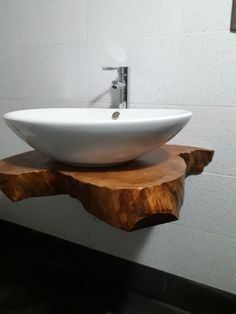 a white sink sitting on top of a wooden counter