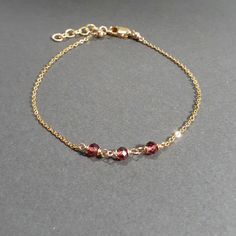 This beautiful handmade bracelet features 3 Genuine Garnets wrapped in 14k Gold Filled or Sterling Silver. Dainty, minimal, and elegant, this bracelet is the perfect finishing touch to any style or event. Wear this beautiful handmade bracelet alone or stacked with others. Makes a great gift to add to any gemstone lover's collection. Perfect to gift for Christmas, Valentine's Day, Mother's Day, and more! Gemstone: Garnet Bead Size: 3.0 mm Gemstone Shape: Rondelle, Faceted Metal: 14k Gold Filled o Elegant Adjustable 14k Gold-filled Beaded Bracelet, 14k Gold Filled Stackable Chain Bracelet Gift, Elegant Handmade Beaded Bracelets As Gift For Her, Elegant Handmade 14k Gold Bracelet, Handmade 14k Gold Elegant Bracelet, Handmade Elegant 14k Gold Bracelet, Elegant Hand-wrapped Beaded Bracelets For Everyday, Elegant Hand Wrapped Beaded Bracelets For Everyday, Elegant Handmade 14k Gold Bracelets