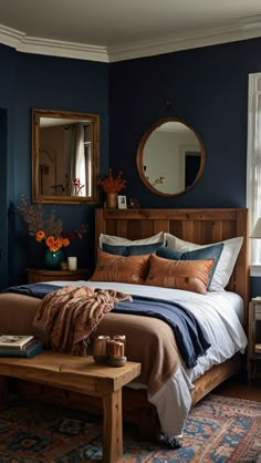 a bed sitting in a bedroom next to a table with a mirror on top of it