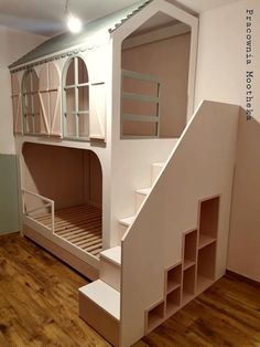 a doll house made out of cardboard with stairs leading up to the top floor and bottom bunk