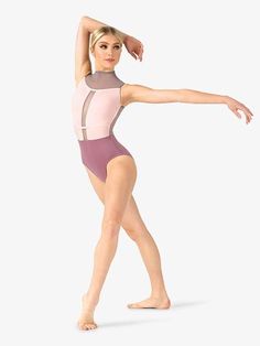 a woman in a pink leotard is posing with her arms stretched out to the side