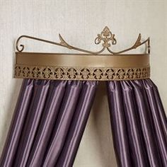 a purple curtain with gold trim hanging on a wall