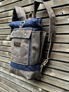 Backpack in waxed canvas, this color is navy blue and grey-brown now also available in medium size. I made it into an everyday backpack/rucksack, with padded waxed canvas straps and leather and clasp closure with buckle. Roll to close top and large outside pocket with flap and pouch button closure. and water bottle pocket on one side. The backside of the pack is padded for comfort. This rucksack is fully lined with a cotton canvas fabric with a padded laptop compartment All the bags are made and Outdoor Waxed Canvas Backpack With Pockets, Outdoor Cotton Backpack With Waxed Finish, Leather Bike Accessories, Harness Pattern, Hipster Backpack, Bushcraft Kit, Waxed Canvas Backpack, Rolltop Backpack, Canvas Leather Bag