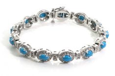 A stunnig round cut diamond tennis bracelet with oval Turquoise The diamonds are total weitht of 3.0ct with SI1 in clarity and G in color set in 14k white gold. The measures 14mm ( 9/16 inch) wide and 7 inches in length. Tthis item is available in yellow gold and 18K gold upon request.  Made In USA Diamond Tennis Bracelet, Tennis Bracelet Diamond, Tennis Bracelet, Round Cut Diamond, Color Set, Round Cut, Made In Usa, 18k Gold, Tennis