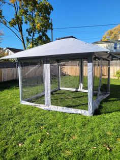 a gazebo in the middle of a yard with grass and fence around it,