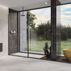 a bathroom with a tub, sink and large glass doors that open to the outside