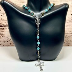 Handmade Rosary Necklace With Blue Jade & Crystal Quartz! This Gorgeous Rosary Necklace Features Eye-Catching 6mm Crystal Quartz And 6mm Blue Jade Stones! The Cross Pendant And Virgin Link Are Made From Durable Alloy With Antique Silver Finish. Both Pieces Are Hypoallergenic And Tarnish-Resistant. The Hand-Linked Wire Is 18 Gauge Silver Over Copper. This Rosary Necklace Is Stunningly Beautiful And Very Unique! Definitely One Of A Kind! Enjoy! Ps 25% Off 3 Or More Items From My Closet! Every Orde Blue 8mm Bead Jewelry For Gift, Blue 8mm Beads Jewelry For Gift, Blue Jewelry With 8mm Beads As Gift, Blue Nickel-free Crystal Necklace As Gift, Blue Necklaces With 8mm Beads For Gift, Blue Necklaces With 8mm Beads As A Gift, Elephant Charm Necklace, Handmade Rosary, Horn Pendant Necklace