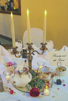 a table with candles and dishes on it