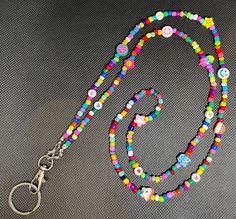 Adorable, fun, colorful lanyard. Perfect for teachers, nurses, or anyone looking for a colorful addition to their day. Multicolor Fun Craft Supplies For Teacher Appreciation, Fun Multicolor Craft Supplies For Teacher Appreciation, Multicolor Personalized Lanyards With Round Beads, Personalized Multicolor Lanyards With Round Beads, Personalized Multicolor Badge Holders For School, Fun Multicolor Lanyards For Gifts, Fun Multicolor Lanyards As Gifts, Personalized Multicolor Badge Holders For Everyday Use, Multicolor Fun Badge Holders For Hobby